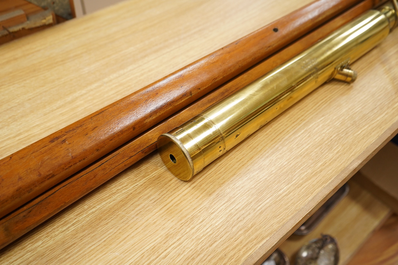 An early 20th century brass telescope with teak tripod by W. Ottway & Co., engraved with; Orion Works Ealing, ‘No.1058, VP 7 to 21 Day & Night Sight Patent 1906’, telescope 65cm long, tripod 160cm. Condition - good.